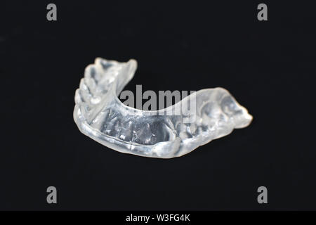 Morsure de dents transparent personnalisé claire garde aligners pour mâchoire inférieure sombre sur fond noir Banque D'Images