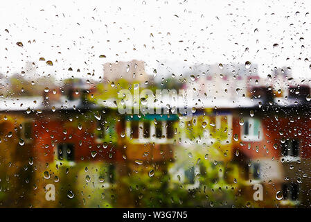 Gouttes d'eau sur la vitre. Au-delà des silhouettes de bâtiments avec windows. Peinture à l'huile Banque D'Images