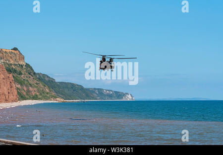 La ville de Sidmouth, Devon, Angleterre. Un hélicoptère de transport lourd Chinook RAF volant le long de la côte sud-ouest à Sidmouth, Devon, Angleterre, Royaume-Uni Banque D'Images