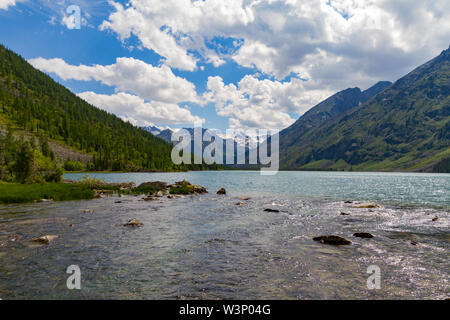 Multinsky averadge dans le lac montagnes de l'Altaï. Paysage pittoresque avec l'eau transparente et la neige des hauts. L'heure d'été. Banque D'Images