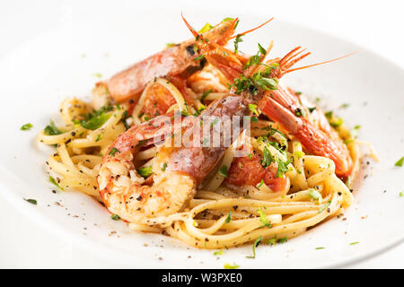 Linguine aux crevettes et l'ail sur une plaque sur fond whita Banque D'Images