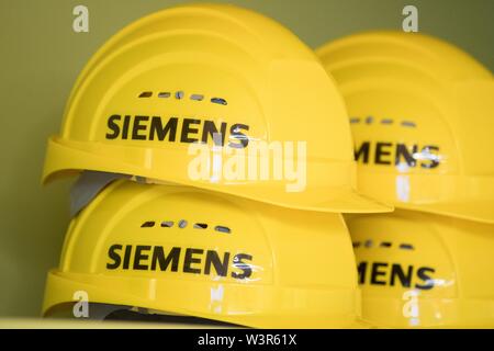 15 juillet 2019, Saxe, Görlitz : jaune avec des casques de la marque 'Siemens' sont sur une étagère dans un hall d'assemblage de l'usine de turbine Siemens. Photo : Sebastian Kahnert/dpa-Zentralbild/dpa Banque D'Images