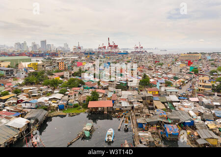 Port de Manille, aux Philippines. Port de mer avec grues de chargement. Vue urbaine avec les régions pauvres et centre d'affaires dans la distance, vue de dessus. Métropole asiatique. Banque D'Images