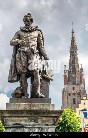 Bruges, Flandre occidentale, Belgique - 17 juin 2019 : Simon Stevin statue avec flèche de OLV Cathédrale en arrière contre cloudscape des pluies. Feuillage vert certains. Pige Banque D'Images