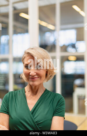Businesswoman standing dans le couloir au bureau Banque D'Images