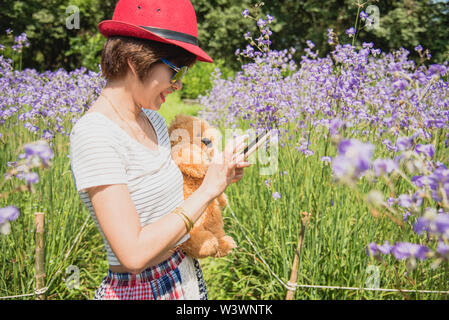 Happy woman a reçu un ours en peluche. Fond vert. Ses beaux yeux à la caméra et à teddy bear.Concept de vacances, anniversaire, World W Banque D'Images