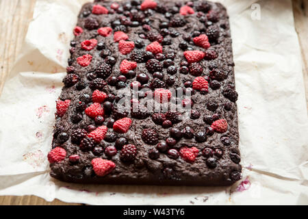 Berry brownies. Brownies au chocolat (de betterave à l'intérieur de la pâte) garni de framboises, mûres et bleuets. Banque D'Images