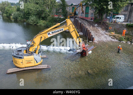 Un barrage temporaire en cours d'installation sur la rivière Kent à Kendal, Cumbria, pour permettre les réparations d'urgence à l'inondation endommagée Pont Victoria Banque D'Images