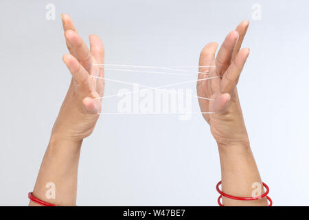 Close up of a woman hands doing cat cradle Stock Photo