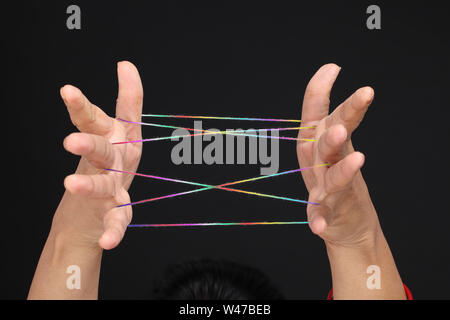 Close up of a woman hands doing cat cradle Stock Photo