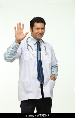 Portrait of a male doctor waving hand Stock Photo