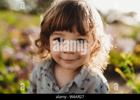 Close up portrait of little boy smiling in backlight Banque D'Images