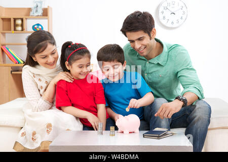 Les parents aident leurs enfants à économiser de l'argent Banque D'Images