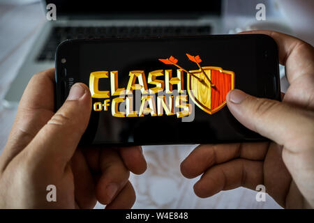 Nizhyn, Ukraine/Juillet-16-2019 : Hands holding smartphone et à l'affrontement des clans. Concept de jeu Android. Banque D'Images