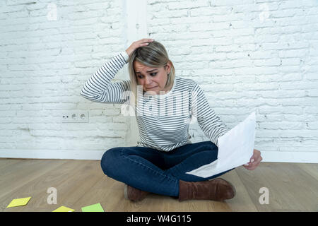 Portrait de jeune femme inquiète stressé et désespéré sur le terrain avec la calculatrice des frais de comptabilité pas en mesure de payer l'hypothèque. Dans le paiement d Banque D'Images