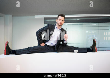 Le businessman se divise à la réception desk in office Banque D'Images