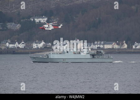 Un hélicoptère de garde-côtes HM (G-MCGT), et la Royal Navy HMS destiné au chasseur de Ramsey (M110), la réalisation d'un exercice pratique sur le Firth of Clyde. Banque D'Images