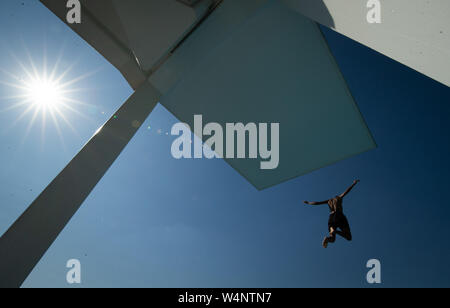 Bielefeld, Allemagne. 24 juillet, 2019. Un nageur passe de la tour de 10 mètres dans une piscine extérieure. Credit : Friso Gentsch/dpa/Alamy Live News Banque D'Images