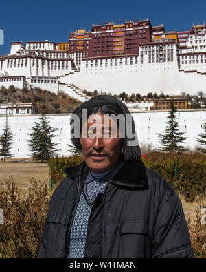 La Chine, Tibet, Lhasa, un pèlerin bouddhiste tibétain du Kham, région est du Tibet visite le palais du Potala Khamba hommes tissent des glands rouge ou noir dans leurs cheveux avec des bijoux en argent. Banque D'Images
