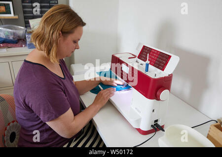 Hamburg Bergedorf, Allemagne. 07 juillet, 2019. Sandra Brunner, fondateur de la start-up 'Einzignaht', est assis dans son studio à une machine à coudre. L'aide au démarrage d'une couture unique produit des vêtements sur mesure pour les enfants handicapés. Credit : Georg Wendt/dpa/Alamy Live News Banque D'Images