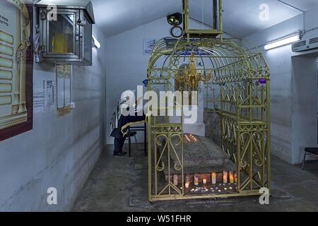 Tombe de Rabbi hassidique Élimélec dans un treillis dorés au cimetière juif de Lezajsk, derrière un Juif orthodoxe priant, Lezajsk, Pologne Banque D'Images