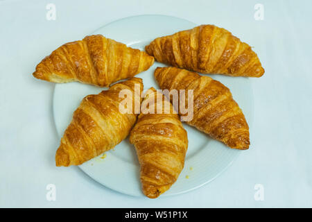 Vue de dessus les croissants sur la plaque blanc et fond blanc Banque D'Images