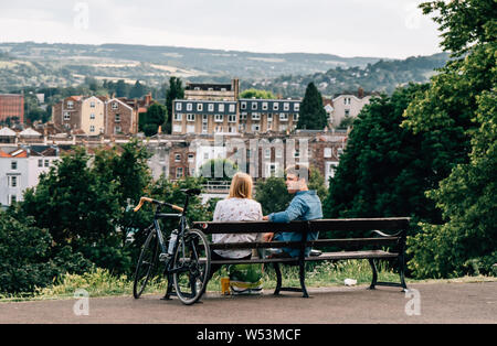 Un jeune homme et femme assise sur un banc à Brandon Hill Park à Bristol, Angleterre du Sud-Ouest Banque D'Images