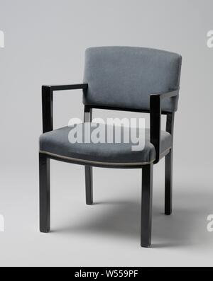 Fauteuil avec accoudoirs anguleux et couverte de bande bleue, Fauteuil de bois laqué noir reposant sur quatre pieds carrés. Les pattes avant sont droites et les pattes postérieures sont légèrement pliés et continuer à l'arrière. Le siège est réglé en quatre lignes, les deux lignes de côté qui sont droits et les lignes avant et arrière plié. Le bas de caisse le dossier est aussi tordue. Télévision accoudoirs angulaire délabré du centre du dossier et reste à l'avant, pas en ligne avec les pattes avant, sur la télévision, qui sont partiellement struts attaché à et en partie contre le siège. La main courante et le siège sont Banque D'Images