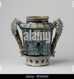 Albarello, multi-couleur peint avec des volutes et fleurs oval blason, Albarello de majolique peints de différentes couleurs. Le vase a un rétrécissement oblique de l'épaule et du pied et un faible cou cylindrique. Les deux oreilles sont des monstres ailés. L'albarello est peint sur les deux côtés avec fine fleur de vignes, avec une fleur sur un côté (anjelier) et de l'autre côté de l'ovale des armoiries., anonyme, Faenza, ch. 1480 - c. 1500, faïence, émail étain, plomb glaze, h 30,5 cm × w 33 cm × d 19 cm Banque D'Images