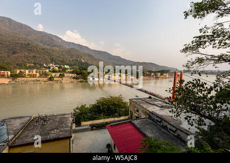 Une vue de vantage Ram Jhula à travers le fleuve Ganga dans la ville spirituelle de Rishikesh dans l'état d'Uttarakhand en Inde Banque D'Images