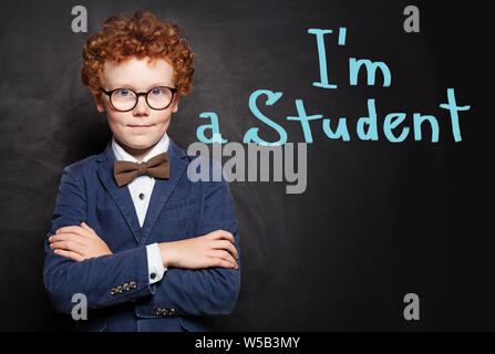 Enfant intelligent étudiant en fonction de l'arrière-plan on chalkboard Banque D'Images
