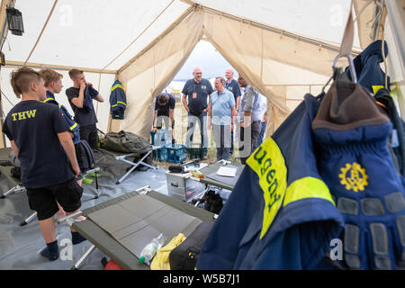 Rudolstadt, Allemagne. 27 juillet, 2019. Bodo Ramelow, Linke (M), premier ministre de la Thuringe, parle avec de jeunes assistants dans une tente du Camp de jeunes 2019 Fédéral THW. Environ 5000 jeunes de toute l'Allemagne en concurrence à l'échelle fédérale des jeunes Camp de l'organisme de secours technique (THW) dans les premiers secours, soins des blessures et de la transformation du bois des compétitions. Crédit : Michael Reichel/dpa/Alamy Live News Banque D'Images