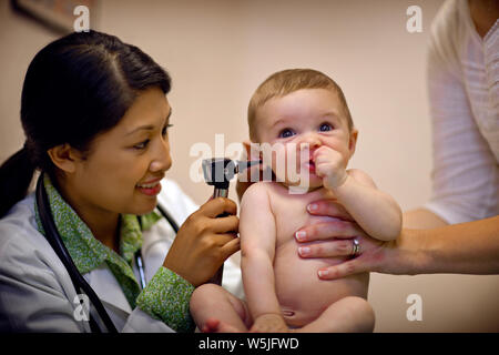 Doctor examining Baby Boy's ear avec un otoscope. Banque D'Images