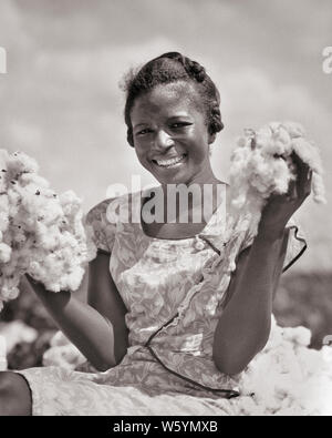 1930 SMILING AFRICAN AMERICAN WOMAN MÉTAYER LOOKING AT CAMERA HOLDING UP DEUX POIGNÉES DE COTON RÉCOLTÉ LOUISIANE USA - c6223 HAR001 HARS CONCOURS DES JEUNES ADULTES HEUREUX JOIE SATISFACTION COTON STYLE LES FEMMES RURALES EMPLOIS UNITED STATES COPIE mi-longueur de l'ESPACE DE REMISE EN FORME PHYSIQUE PERSONNES UNITED STATES OF AMERICA EXPRESSIONS CONFIANCE AGRICULTURE B&W NORTH AMERICA CONTACT OCULAIRE DE COMPÉTENCES NORD-AMÉRICAIN DE L'OCCUPATION DES RÊVES DE BIEN-ÊTRE COMPÉTENCES FORCE JOYEUSE COURAGE africains-américains africains-américains EXCITATION NOIR ORIGINE LOUISIANE FIERTÉ DE PROFESSIONS PRIS CONCEPTUEL ÉLÉGANT JOYEUX sourires Banque D'Images