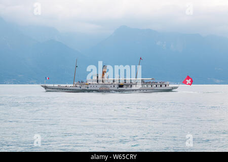 La plus ancienne restaurée Belle Epoque vintage paddle steamboat Montreux traversant le lac de Genève (lac Léman) entre la Suisse et la France avec Alpes mont Banque D'Images