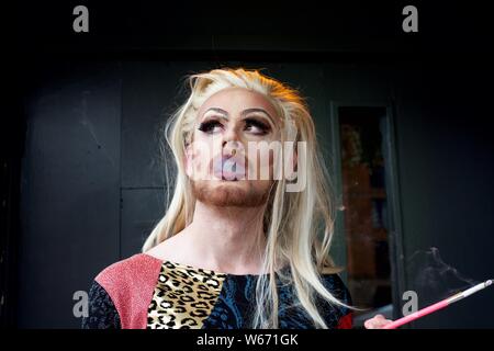 Drag Queen fumer une cigarette Banque D'Images