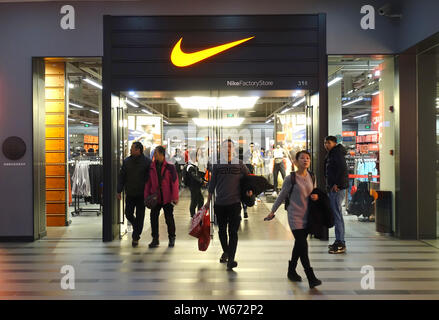 --FILE--piétons devant une boutique Nike à Shanghai, Chine, le 2 juillet 2018. Nike Inc a déclaré lundi qu'augmenter les salaires pour environ 7 500 employés f Banque D'Images