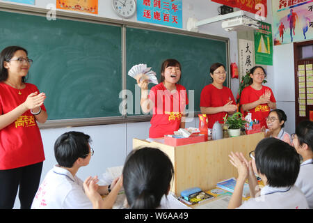 Un enseignant chinois parle à ses élèves qui vont se présenter à l'examen d'entrée du collège national annuel, également connu sous le gaokao, avant de leur 5-yuan bankn Banque D'Images