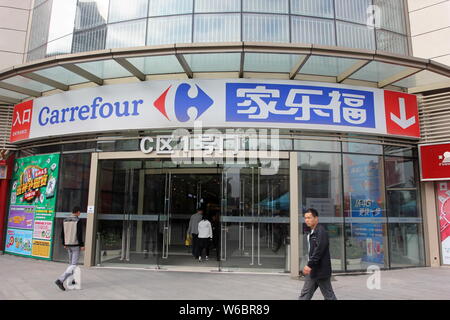 --FILE--piétons passent devant un supermarché de Carrefour à Wuhan, Chine centrale, la province du Hubei, 16 avril 2016. Le géant des supermarchés européens Ca Banque D'Images