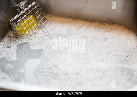 Shaker en usage de savon dans la cuisine. Utilisé pour créer de l'eau savonneuse pour laver la vaisselle dans l'évier. Les gens ont utilisé dans le bon vieux temps avant de savon liquide. L'avenir. Banque D'Images