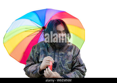 L'homme brutal dans un camouflage avec une barbe avec un regard menaçant et un parapluie de couleur à l'appui des personnes LGBT Banque D'Images