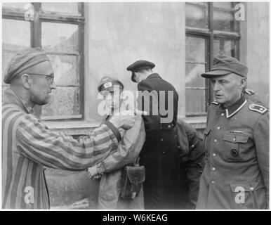 Fédération esclave laboureur parmi les prisonniers libérés par la 3e Division blindée de points sur l'ancien garde nazi qui a battu brutalement les prisonniers. L'Allemagne ; les notes générales : utilisation de la guerre et des conflits Nombre 1111 lors de la commande d'une reproduction ou demande d'informations sur cette image. Banque D'Images