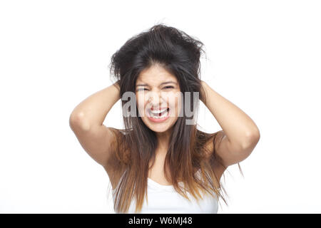 Young woman frustrated with her tangled hair Stock Photo