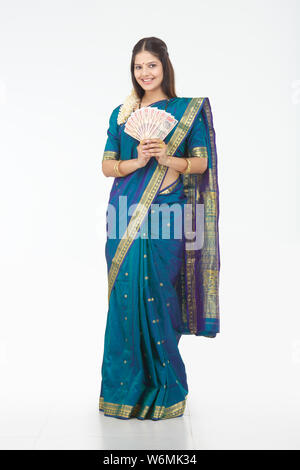 South Indian woman showing thousand rupees banknotes Stock Photo