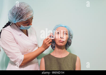 Faire mesothreads femme d'âge et de levage, la cosmétologie. Chirurgie esthétique pour éliminer les signes de vieillissement. Beauté Visage, contour du visage, plastique Banque D'Images