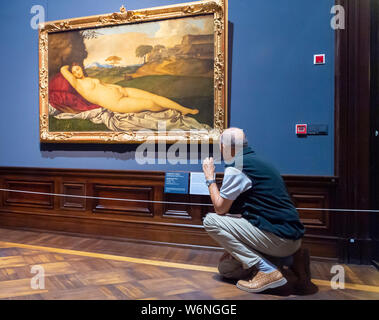 Dresde, Allemagne. 09Th Aug 2019. Un visiteur regarde le travail du bois 'Venus' de Giorgione/Tizian dans l'exposition "Faits saillants de la Galerie des vieux maîtres' dans Semperbau. L'exposition dure du 2 août au 3 novembre 2019 et offre un aperçu de la 3800 œuvres de la collection. Credit : Matthias Rietschel/dpa-Zentralbild/ZB/dpa/Alamy Live News Banque D'Images