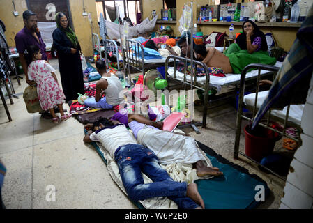 Les patients atteints de dengue couchées sur le sol et sur le lit à l'extérieur du Shaheed Suhrawardy Medical College Admission de l'hôpital l'article de Dhaka, Banglade Banque D'Images