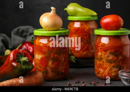 Salade de légumes en bocaux pour l'hiver de tomates, carottes, oignons et poivrons, entente horizontale Banque D'Images