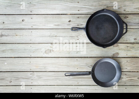 Fonte d'acier au carbone vs vs casseroles en téflon. Poêle de cuisine bataille pour comparaison options de cuisson plus saine de cuisinière à four à feu de camp. Vide Vide Banque D'Images