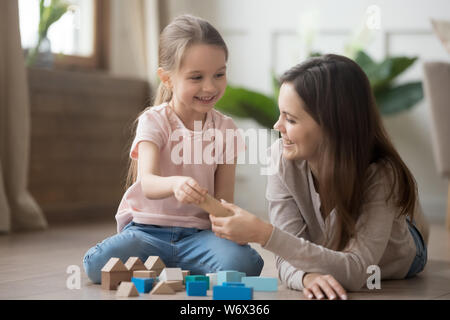 Mère ou gardienne jouer avec petit enfant avec blocs de jouets Banque D'Images